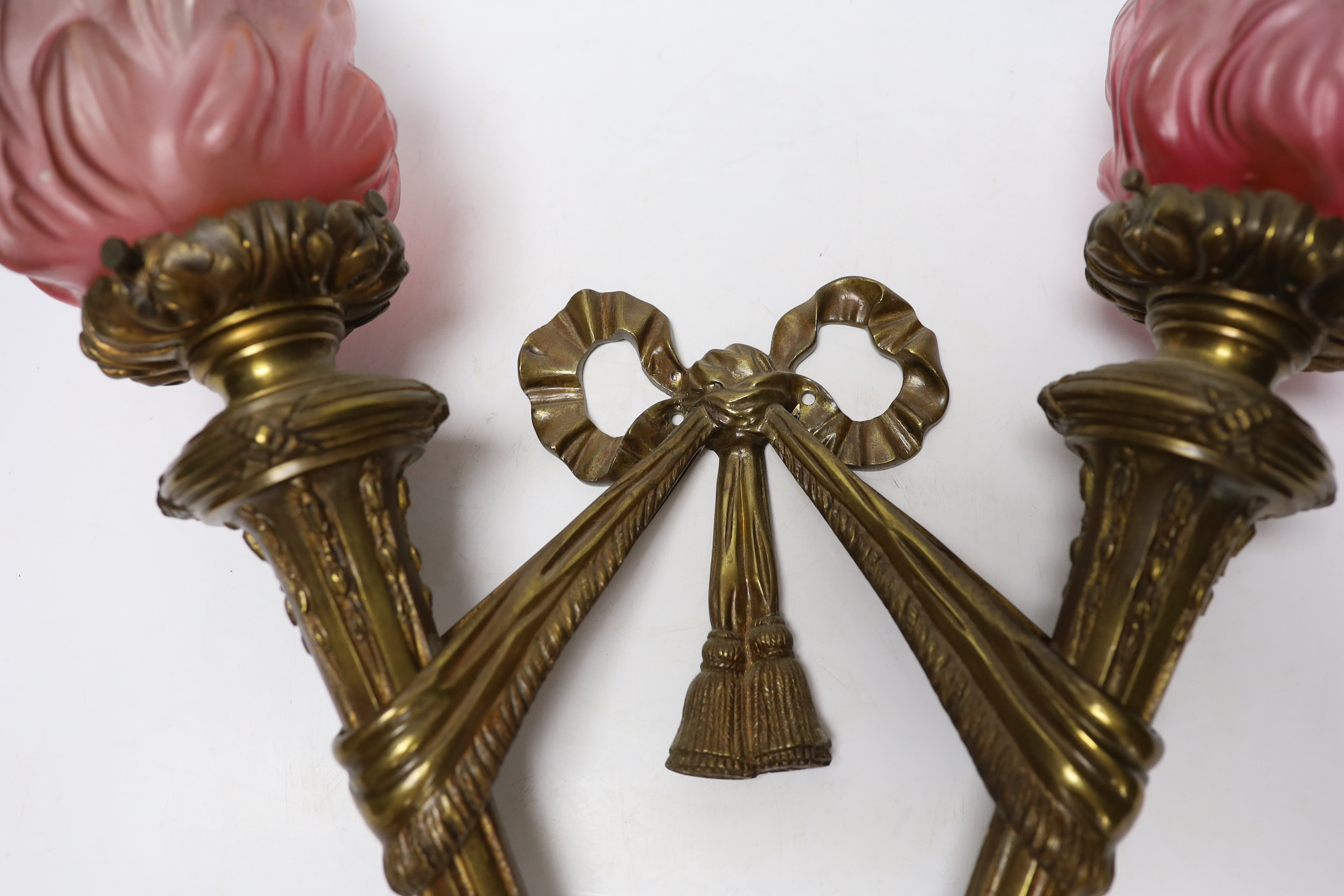A Louis XVI style bronze double torch wall light with ‘flame’ glass shades, 63cm